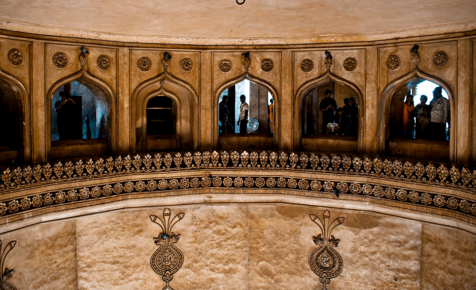 Sacred Alam-inspired emblem with calligraphy detail on Charminar’s historic surface.